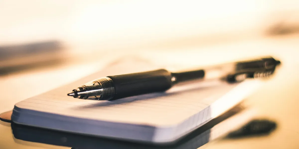 A pen ontop of a notebook indicating the importance of keeping notes